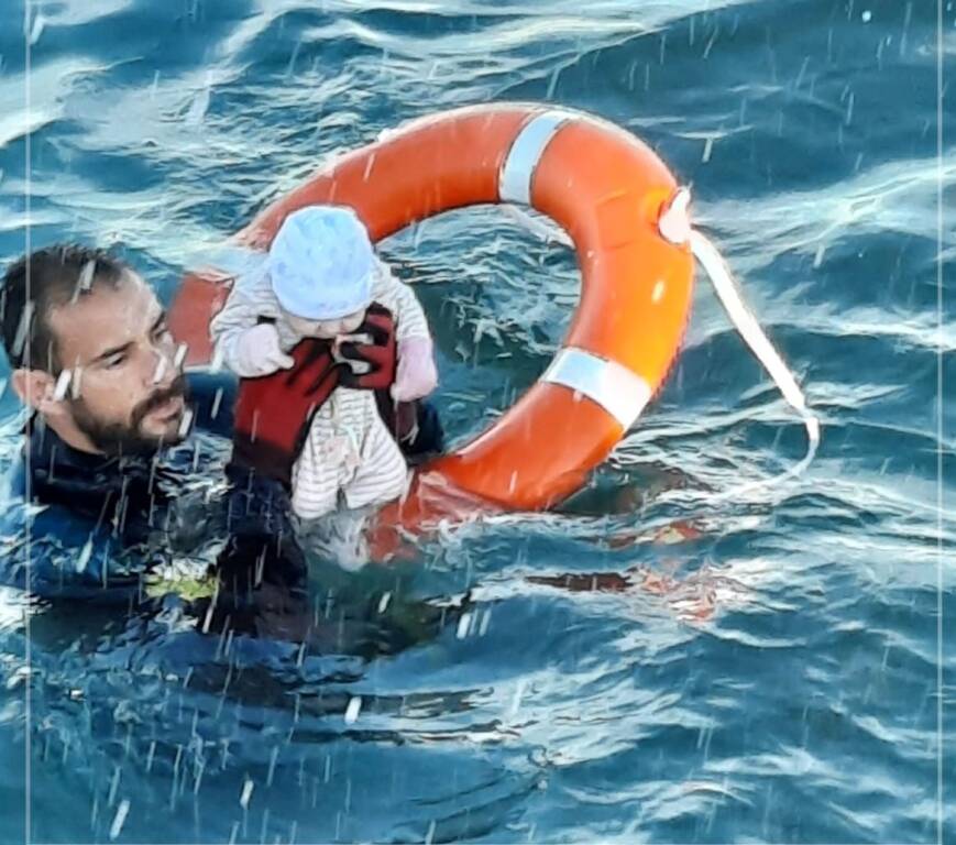 Agente salva un neonato in mare aperto: la foto simbolo della crisi dei migranti a Ceuta